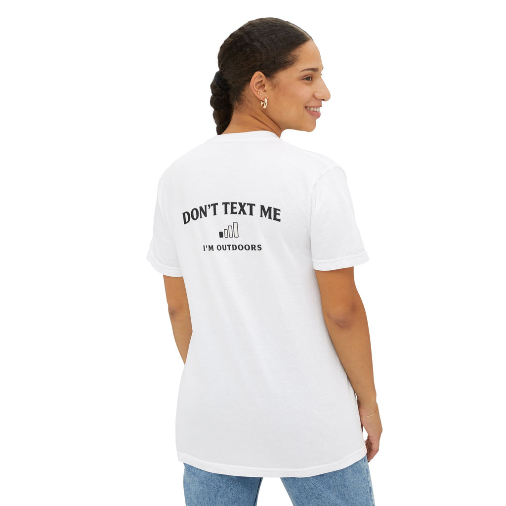 Back view of female model wearing white unisex outdoor pocket tee with "Don't Text Me I'm Outdoors" design, made for fishing and outdoor lifestyle.